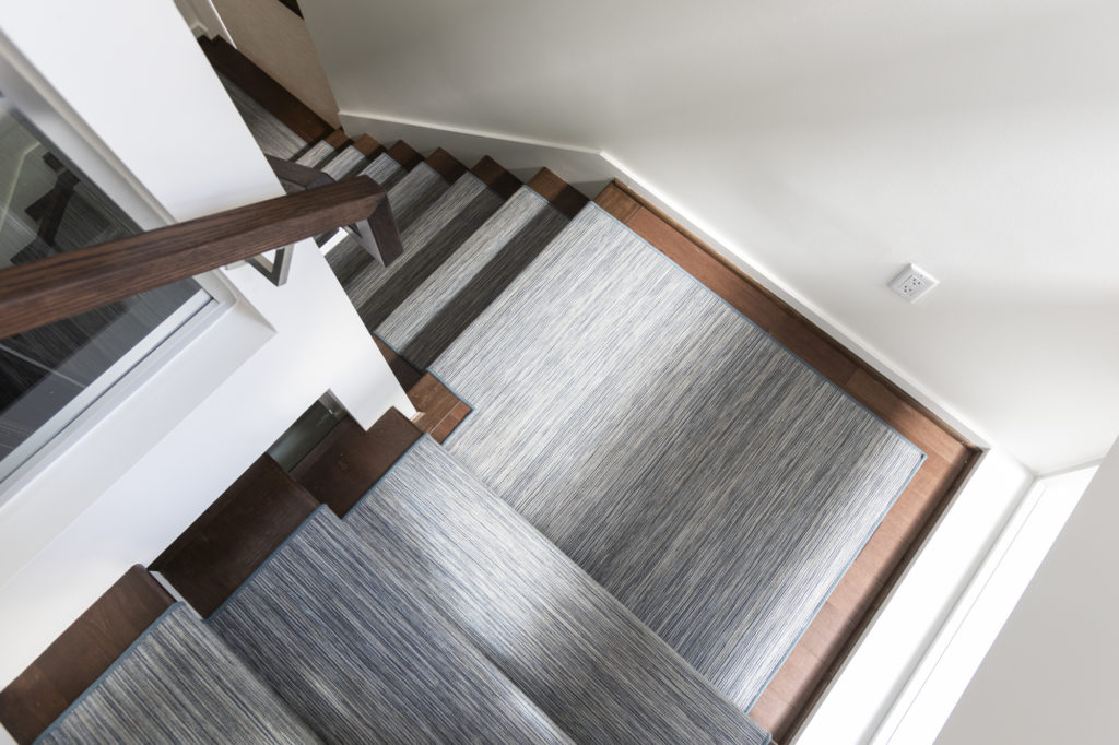 Dark wood stairs with a chic stair runner are stunning flooring options. Dark wood stairs with a chic carpet runner take flooring options to the highest standards.