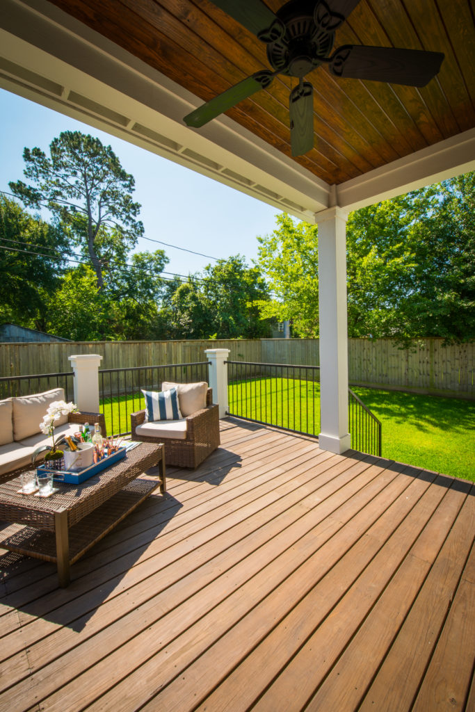 An outdoor deck with overhead fan provides for nice outside seating. covered outdoor seating on deck