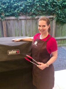 Houston interior decorator features prize drawings of aprons. Pamela O'Brien sports her PHD apron that's ideal for grilling.